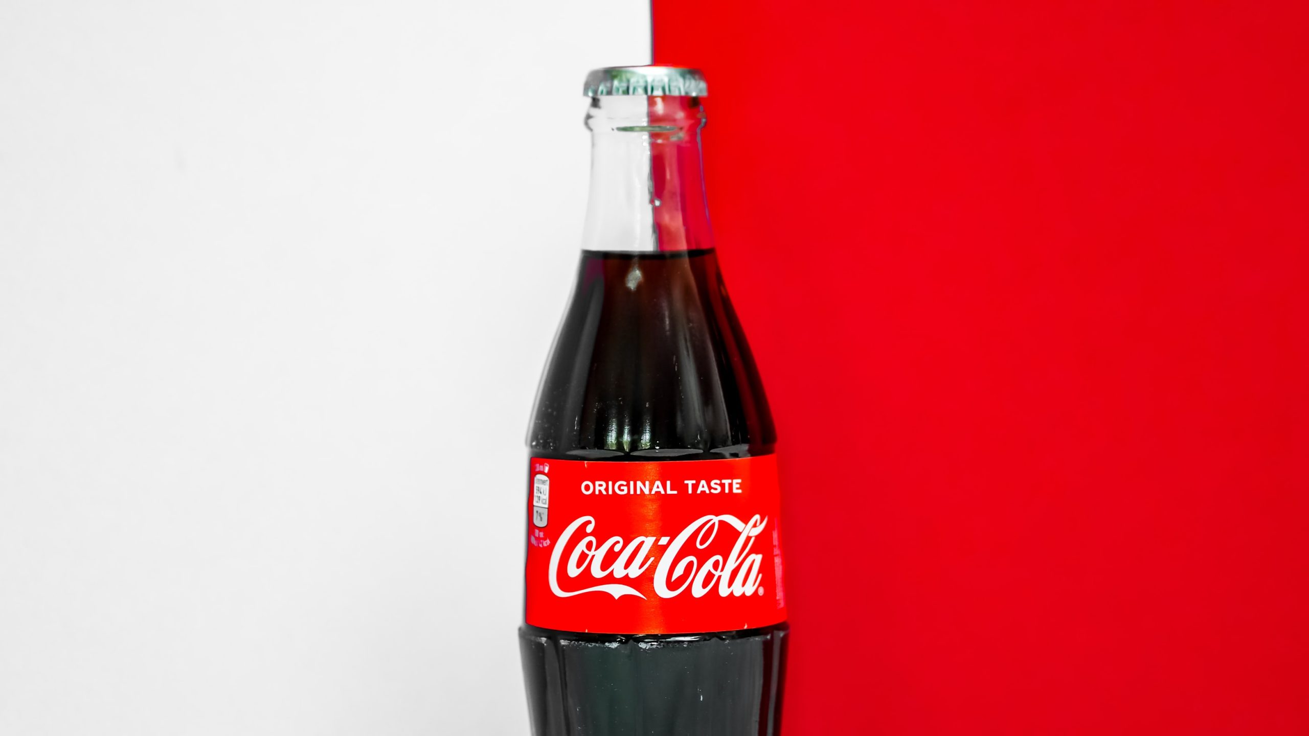 Coca Cola bottle on a red and white background