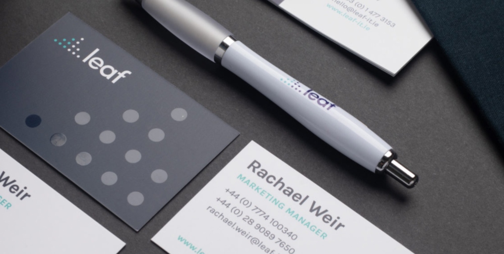 black and white business cards and a pen