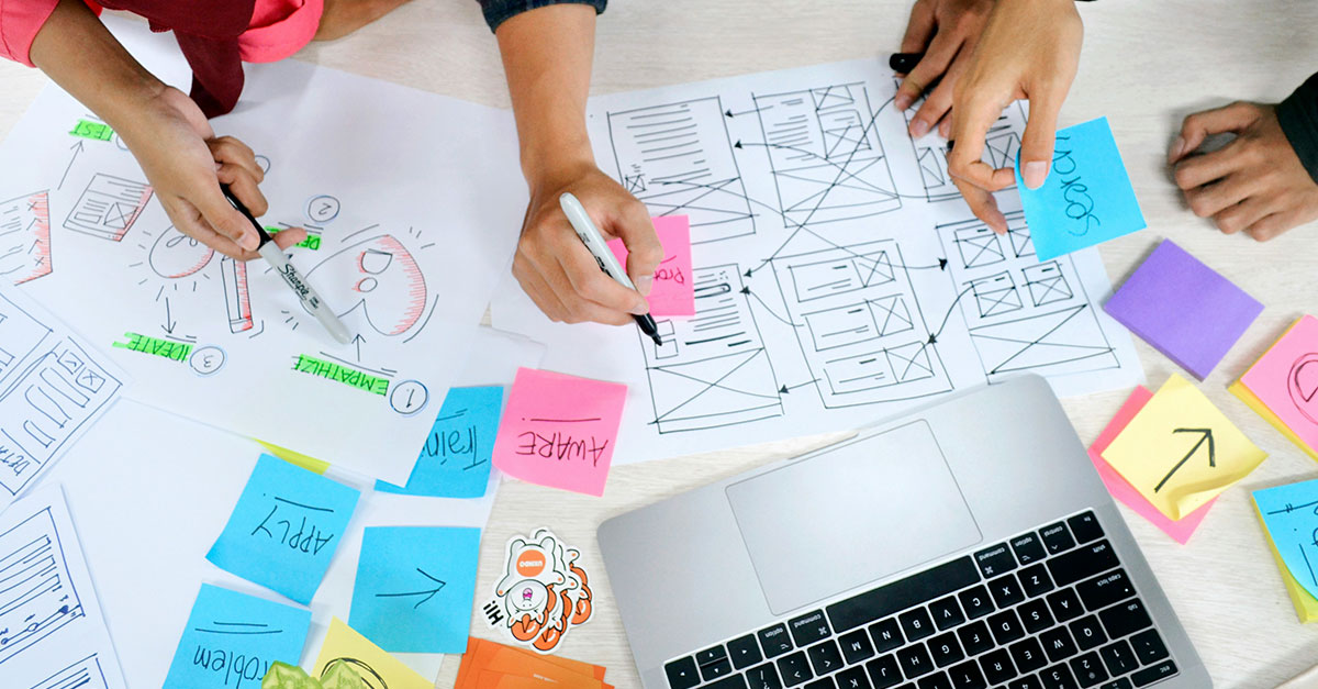 brand audit sheets on a desk with people around the desk