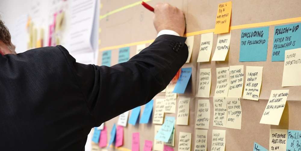 coloured sticky notes on a board