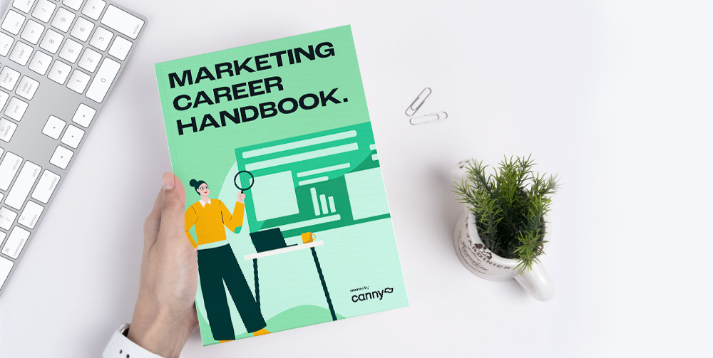 person holding marketing career handbook