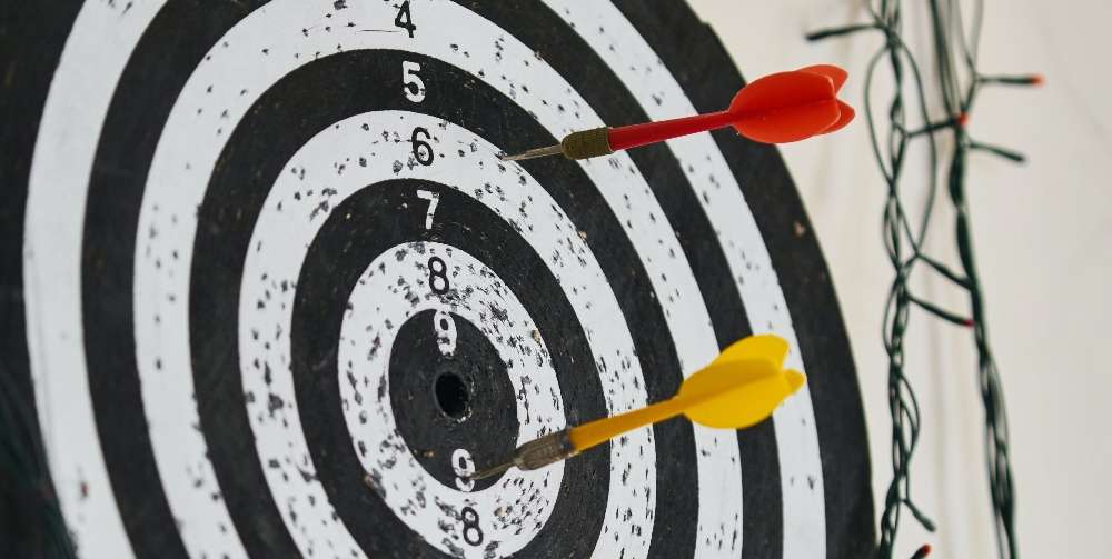 red and yellow darts on a dartboard