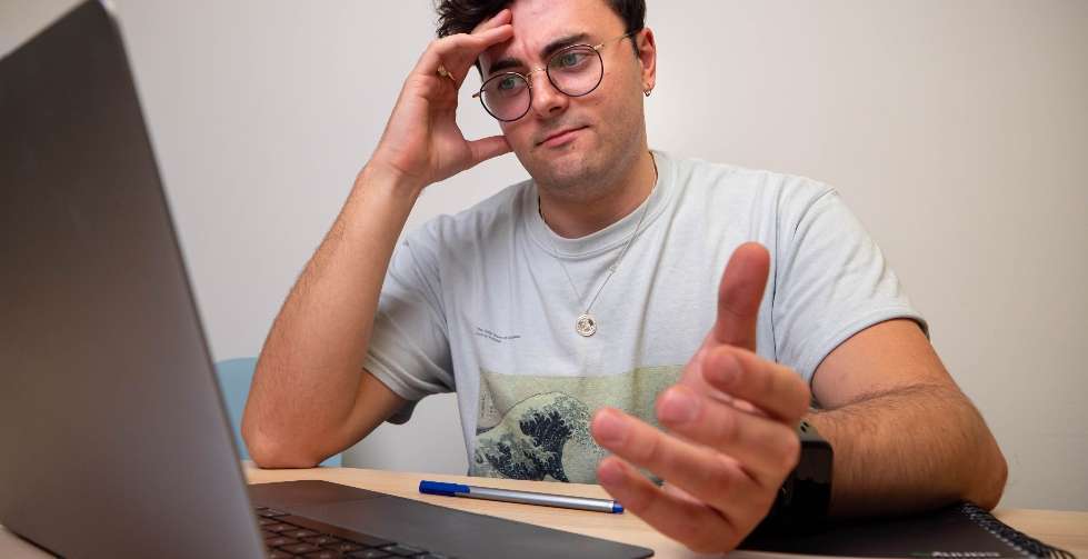 Confused Man Frustrated with Laptop
