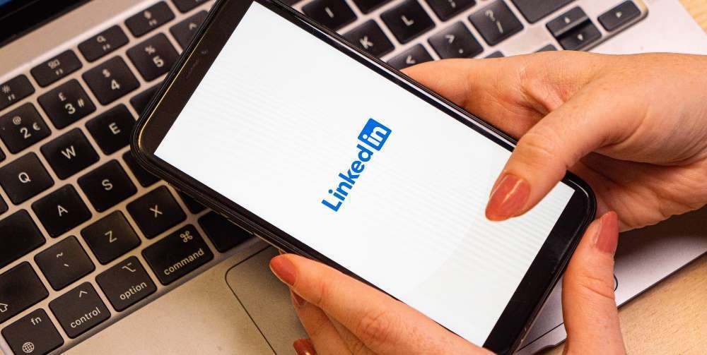person using LinkedIn on their iPhone
