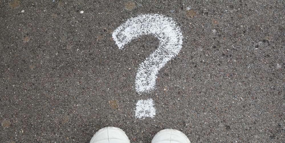 white question mark on pavement