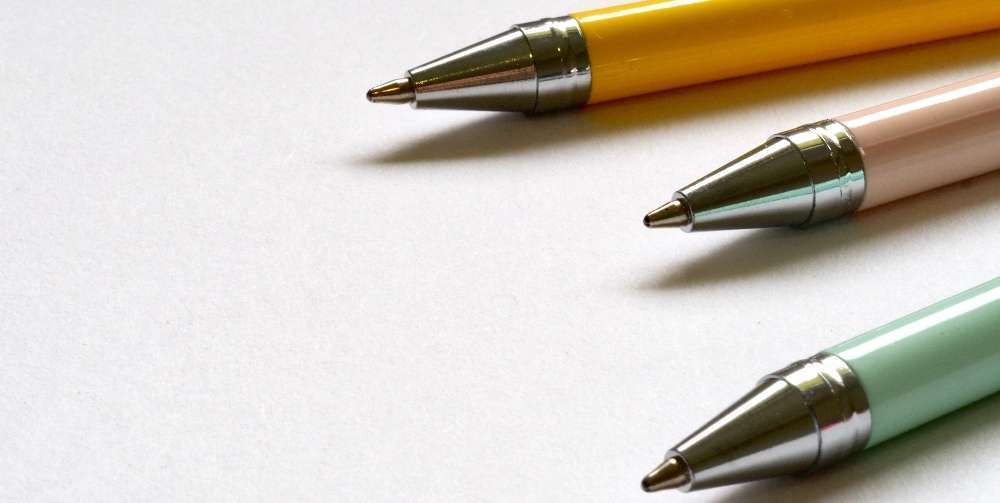 three coloured ball point pens