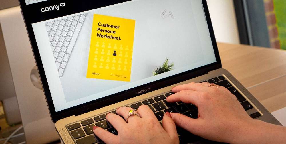 person downloading Canny customer worksheet from a laptop