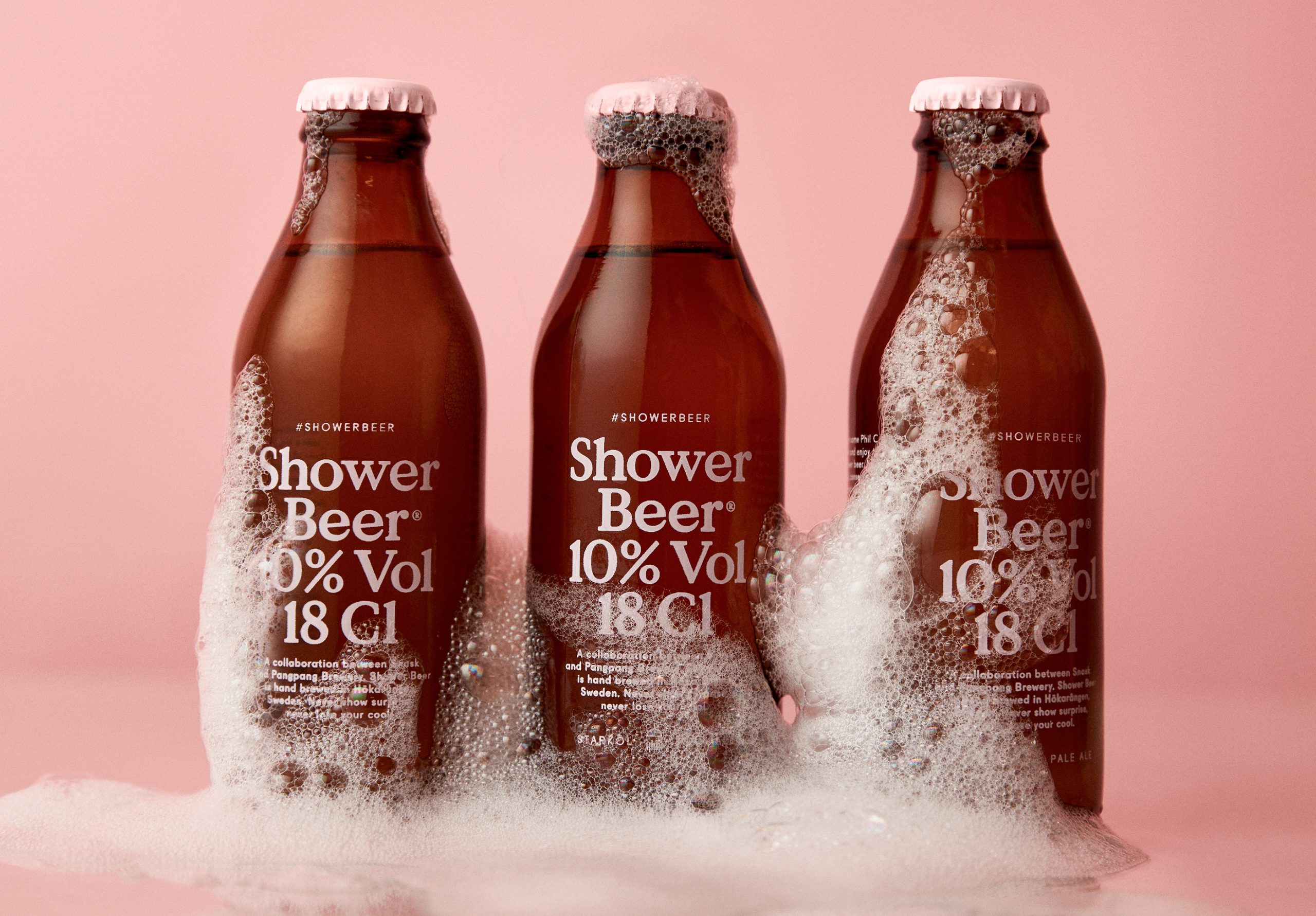 Showerbeer bottles on pink background