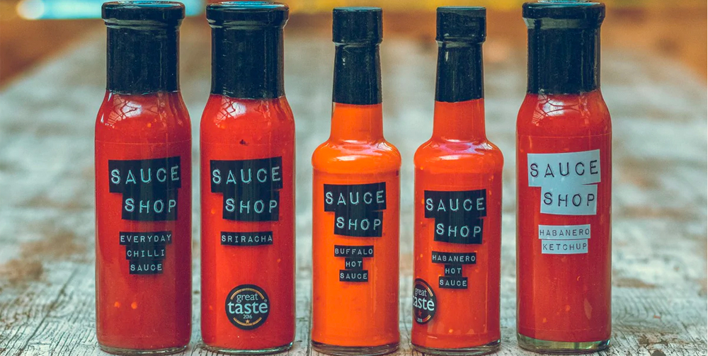 A collection of Sauce Shop sauces sitting outside