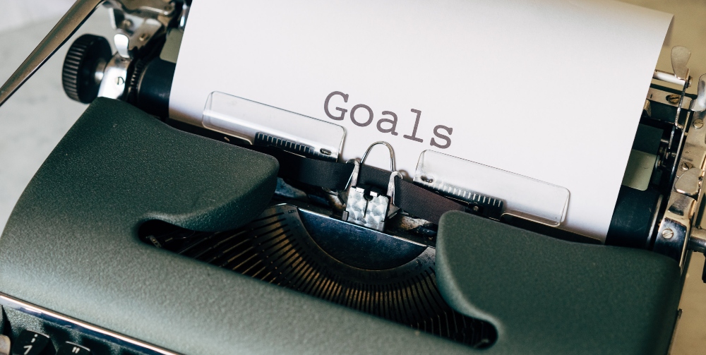 paper reading _goals_ on a typewriter