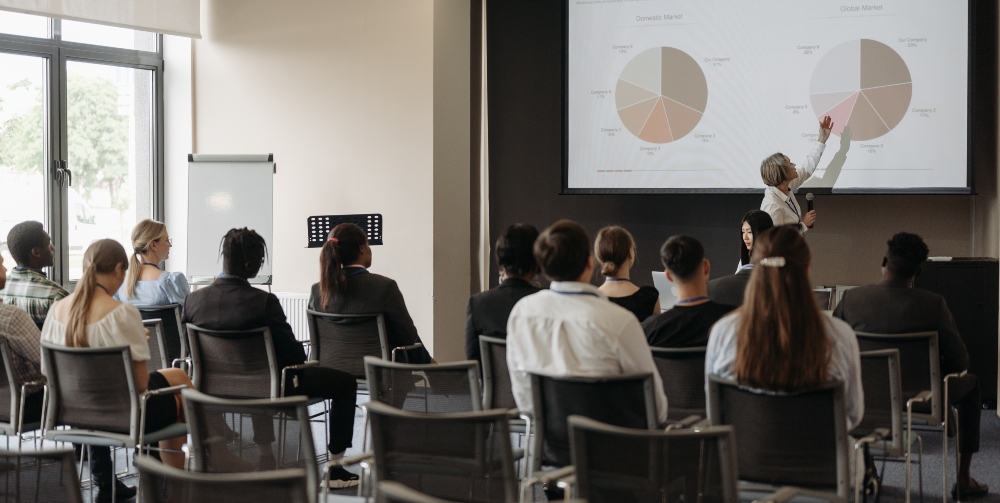 person presenting to group of people