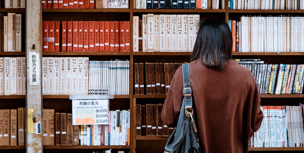 person looking at bookcase