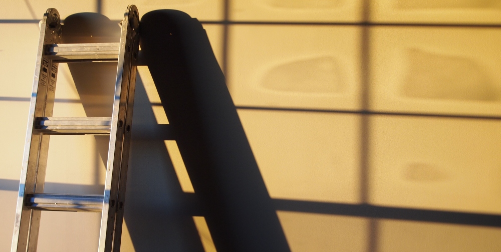 wooden ladder leaning on wall