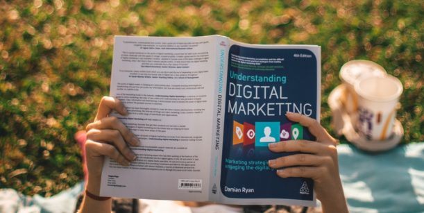 Person holding digital marketing book