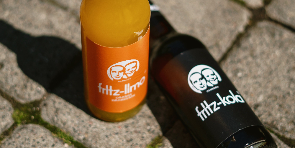 two bottles of fritz limo lying on the ground