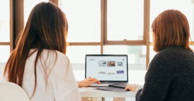 Two people looking at a website